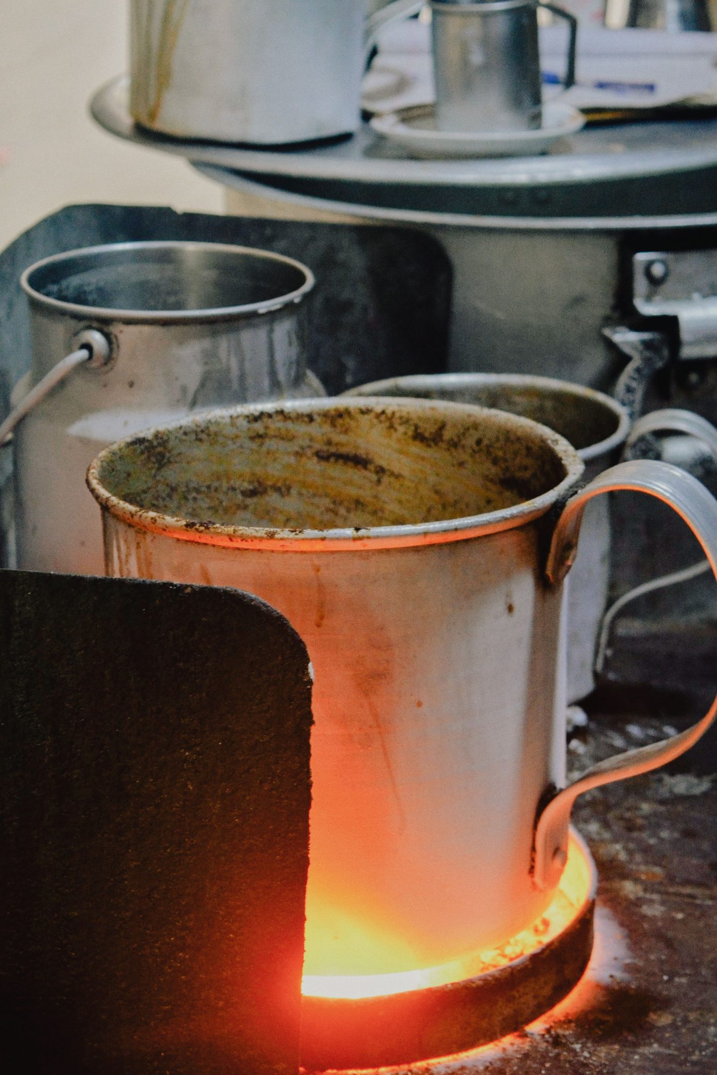 Kettles and milk pots on the stove — the first boil of the day